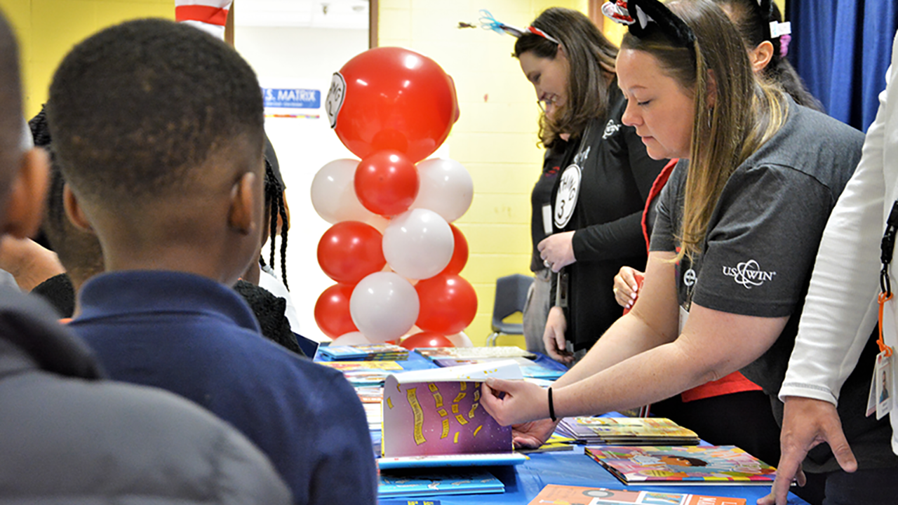 WIN members pass out books to students at North Jackson Elementary School